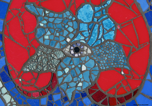 Picture of glass mosaic on cement board detail of acqua flower with eye in the middle inside of red and blue