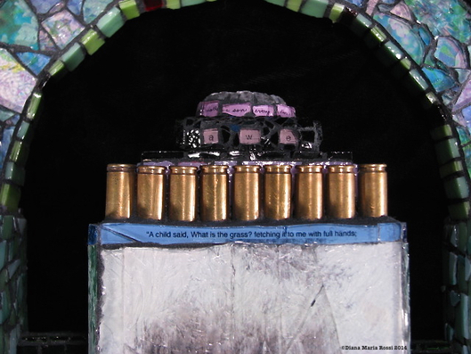 Picture of glass mosaic on wood with next and bullet shell casings made of brass and text 