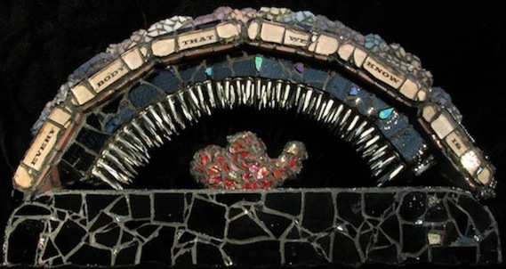 Picture of art glass mosaic on wood: arch shaped with heart under many nails with text: Every Body That We Know Is