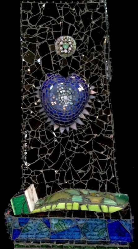 photo of glass mosaic on wood/ blue heart with lavender, white spokes in black background with  bed on bottom and brooch in blackbackground. black background has mirror as stars