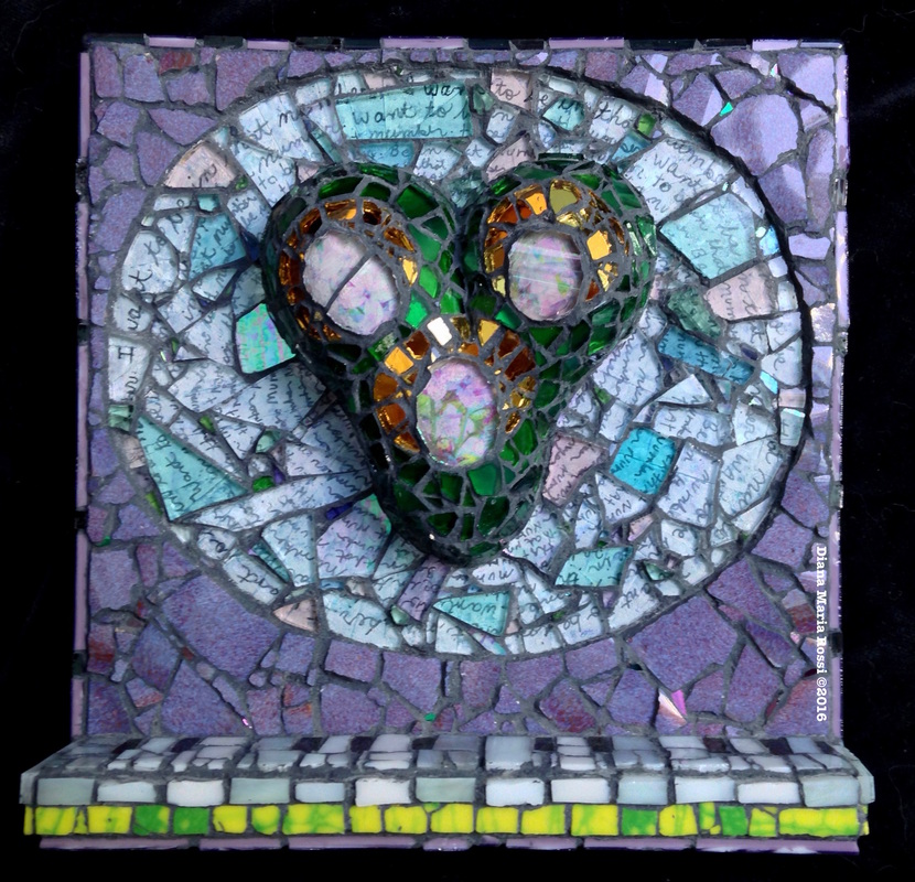 photo of glass and ceramic mosaic on wood. There is a green heart shape with three circles over photos of lilacs, surrounded by gold mirrored glass.Around this heart there is a halo that is composed of text under glass. The text reads: I want to be in that number, repeated over and over. The background is a deep lavender color in ceramic. On the bottom, there is a 3-d shelf that emulates a piano keyboard.