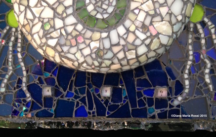 detail of photo of glass heart mosaic / bottom of off white heart in cobalt background with the 