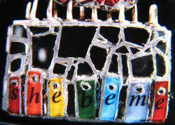 Picture of art glass mosaic on wood with nails and text: she be me
