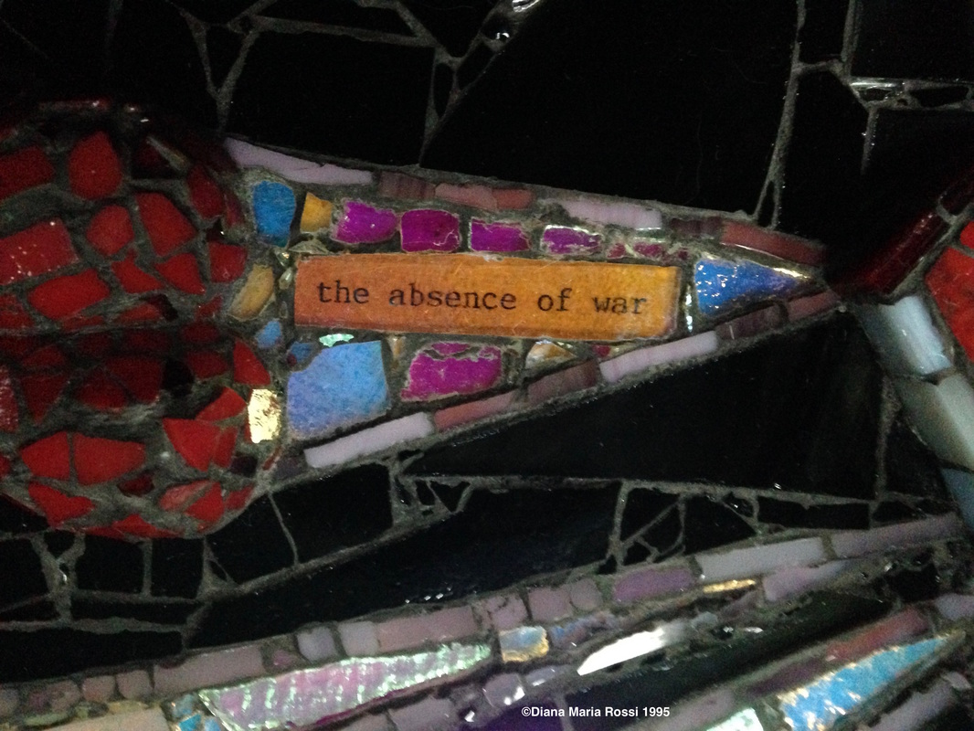 photo of detail of glass mosaic with text that reads: the absence of war
