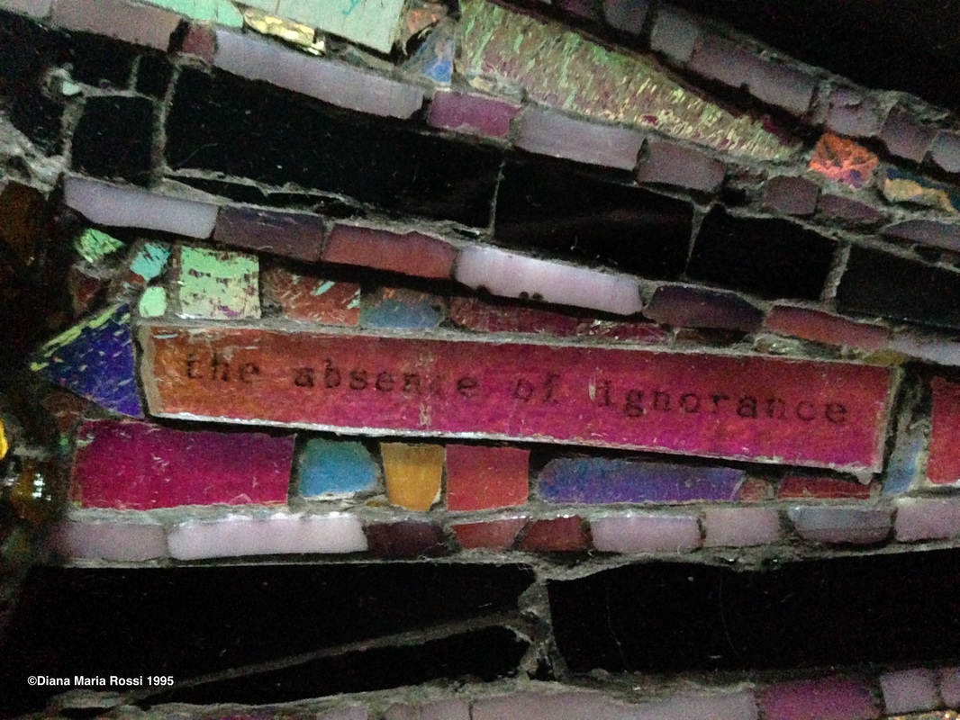 photo of detail of glass mosaic with text that reads: the absence of ignorance