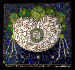 photo of glass mosaic heart. the heart is off white with a green circle in the middle with white streams floating off the sides from the spokes which are green and on top of the heart like a russian tiara. the background is cobalt blue and there is a text under the heart which says 